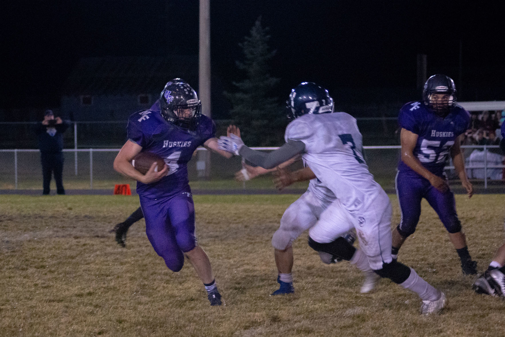 North Fremont's Oberhansley reaches out to stiff arm a West Jefferson defender.